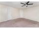 Spacious bedroom featuring a ceiling fan and two closets at 2903 Rockingham Sw Ct, Concord, NC 28025