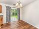 Dining area featuring modern light fixture and sliding glass door to backyard at 2903 Rockingham Sw Ct, Concord, NC 28025