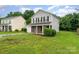 Attractive two-story home featuring gray siding, a brick accent, a lush green lawn, and an attached single-car garage at 2903 Rockingham Sw Ct, Concord, NC 28025