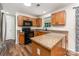 Kitchen with black appliances, eat-in breakfast bar, and wood cabinets at 2903 Rockingham Sw Ct, Concord, NC 28025