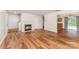 Open living room with fireplace and hardwood floors leading to kitchen at 2903 Rockingham Sw Ct, Concord, NC 28025