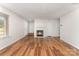 Inviting living room featuring a fireplace, wood-look floors, and ample natural light from a large window at 2903 Rockingham Sw Ct, Concord, NC 28025