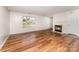 Bright living room featuring a fireplace, wood-look floors, and an inviting atmosphere with natural light at 2903 Rockingham Sw Ct, Concord, NC 28025