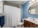 Bright bathroom featuring blue accent wall, vanity, and shower with curtain at 348 Zocalo Dr, Gastonia, NC 28056