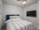 Comfortable bedroom with a ceiling fan, TV, and a cozy striped bedspread at 348 Zocalo Dr, Gastonia, NC 28056
