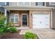 Inviting front porch featuring a brick facade, rocking chairs, and a one car garage at 348 Zocalo Dr, Gastonia, NC 28056