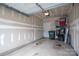 Unfinished garage space is ready for customization with overhead lighting and painted concrete floors at 348 Zocalo Dr, Gastonia, NC 28056