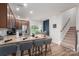 Eat-in kitchen featuring a breakfast bar, stainless appliances, and a staircase at 348 Zocalo Dr, Gastonia, NC 28056