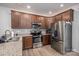 Well-lit kitchen featuring stainless steel appliances, granite countertops, and wood cabinets at 348 Zocalo Dr, Gastonia, NC 28056