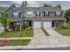 Exterior street view showcasing townhomes with attached garages and manicured lawns at 348 Zocalo Dr, Gastonia, NC 28056