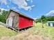 Exterior side view of a red home with a metal roof and exterior door at 362 Sandburg Rd, Union Grove, NC 28689