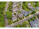 An aerial view showcasing the property, neighboring houses and mature trees at 376 Delburg St, Davidson, NC 28036