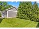 Well-maintained backyard with a lawn, garage, and mature trees at 376 Delburg St, Davidson, NC 28036