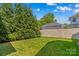 Well-maintained backyard featuring a lawn, privacy fence, and mature trees at 376 Delburg St, Davidson, NC 28036