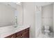 Bathroom featuring a large mirror, marble countertop, and tiled shower/tub at 376 Delburg St, Davidson, NC 28036