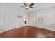 Spacious bedroom features wood floors, a ceiling fan, and plantation shutters for a warm, inviting ambiance at 376 Delburg St, Davidson, NC 28036