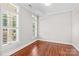 Bedroom with hardwood floors, large windows, and neutral paint at 376 Delburg St, Davidson, NC 28036