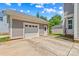 Attached two car garage in neutral colors featuring a white door and trimmed with white moulding at 376 Delburg St, Davidson, NC 28036