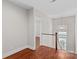 Upstairs hallway with hardwood floors and natural light from the staircase window at 376 Delburg St, Davidson, NC 28036