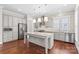 Modern kitchen with stainless steel appliances, granite countertops, and a central island with pendant lighting at 376 Delburg St, Davidson, NC 28036