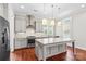 Well-appointed kitchen with stainless appliances, granite counters, stylish lighting and gray cabinetry at 376 Delburg St, Davidson, NC 28036