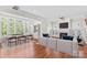Open-concept living room and dining area with fireplace and hardwood floors at 376 Delburg St, Davidson, NC 28036
