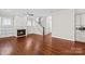 Cozy living room with hardwood floors, fireplace, built-in shelving, and staircase at 376 Delburg St, Davidson, NC 28036