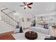 Staged living room with hardwood floors, a modern white sofa, and an open floor plan at 376 Delburg St, Davidson, NC 28036