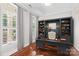 Home office with custom built-in bookshelves, desk, and natural light from windows at 376 Delburg St, Davidson, NC 28036