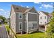 Rear elevation of a two-story home with grey siding and large windows at 376 Delburg St, Davidson, NC 28036