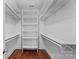 Organized walk-in closet with shelving and hanging rods for optimal storage at 376 Delburg St, Davidson, NC 28036