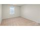 An empty bedroom featuring neutral paint, carpet, and a window with blinds at 4116 Lurelin Ln, Charlotte, NC 28262