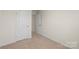 An empty bedroom features neutral carpet, paint, and a closet at 4116 Lurelin Ln, Charlotte, NC 28262