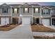 New townhome showing garage, stone accents, neutral paint, and a manicured lawn at 4116 Lurelin Ln, Charlotte, NC 28262