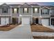 Charming townhome with stone accents, a two-car garage and a well-manicured lawn at 4116 Lurelin Ln, Charlotte, NC 28262