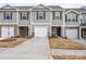 Charming townhome featuring stone accents, a one-car garage, and a welcoming front entrance at 4116 Lurelin Ln, Charlotte, NC 28262