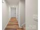 Hallway with wood-look flooring and white walls leading to the front door at 4116 Lurelin Ln, Charlotte, NC 28262