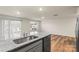 Modern kitchen with granite countertops, stainless steel sink, and view of the adjacent living space at 4116 Lurelin Ln, Charlotte, NC 28262