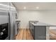 A modern kitchen with stainless steel appliances, gray cabinets, and a spacious bar at 4116 Lurelin Ln, Charlotte, NC 28262