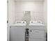 Bright laundry room featuring a side-by-side washer and dryer, and wire shelving at 4116 Lurelin Ln, Charlotte, NC 28262