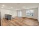 Open-concept living room with hardwood floors and lots of natural light at 4116 Lurelin Ln, Charlotte, NC 28262