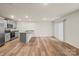 Bright open-concept living space featuring hardwood floors, sliding glass door, and kitchen bar at 4116 Lurelin Ln, Charlotte, NC 28262