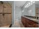 Bathroom featuring double sink vanity with dark wood cabinets and a tiled shower at 422 Drake Ln, Salisbury, NC 28146