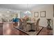 Dining room featuring hardwood floors, a modern chandelier, and an open concept to the living room at 422 Drake Ln, Salisbury, NC 28146