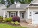 Home featuring a tidy lawn, stone accents, and an inviting front entrance with a porch at 422 Drake Ln, Salisbury, NC 28146