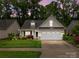 Charming single-Gathering home featuring a two-car garage, manicured lawn, and mature trees at 422 Drake Ln, Salisbury, NC 28146