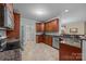 Kitchen featuring stainless steel appliances, granite countertops, wood cabinets, and tile floor at 422 Drake Ln, Salisbury, NC 28146
