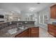 Close up of kitchen featuring stainless steel sink, wooden cabinets, and granite counters at 422 Drake Ln, Salisbury, NC 28146