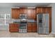 Kitchen with stainless steel appliances, wood cabinets, granite counters and tile flooring at 422 Drake Ln, Salisbury, NC 28146