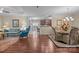 Spacious living room with a ceiling fan and hardwood floors, seamlessly connected to the dining area at 422 Drake Ln, Salisbury, NC 28146